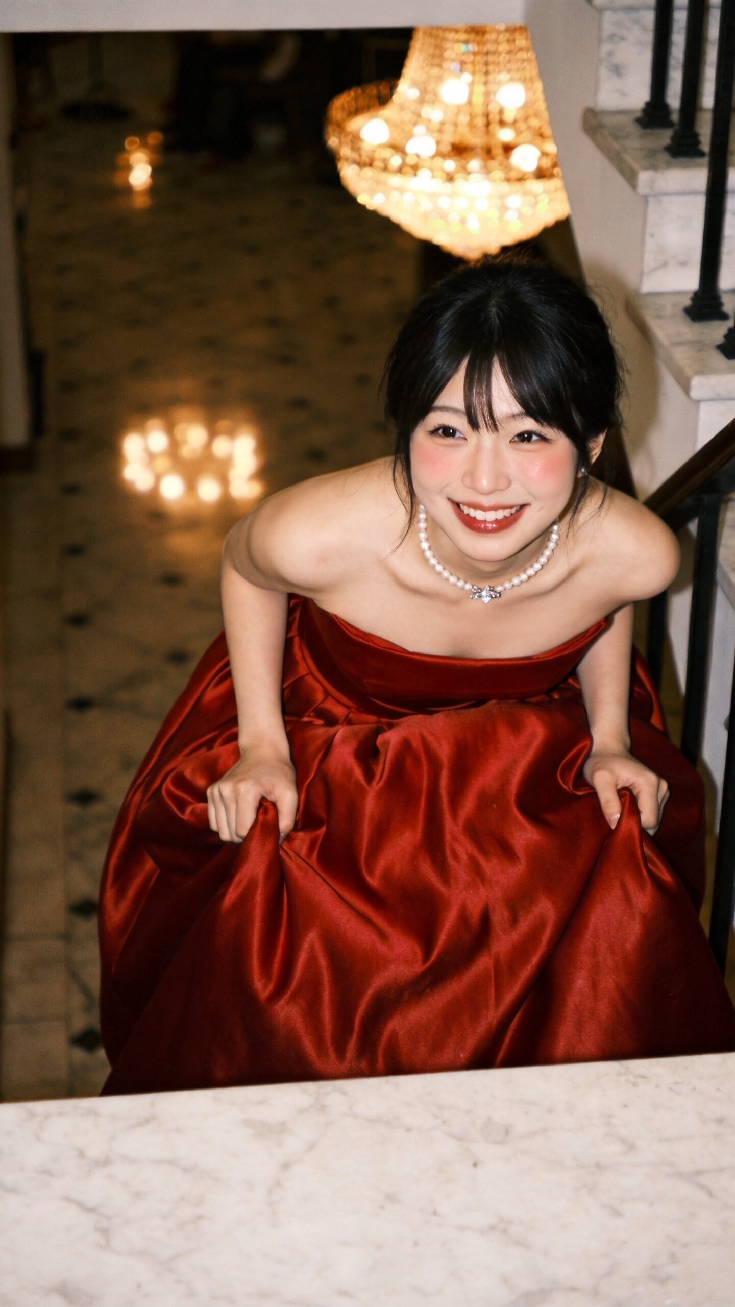 Crimson Silk Beneath the Chandelier