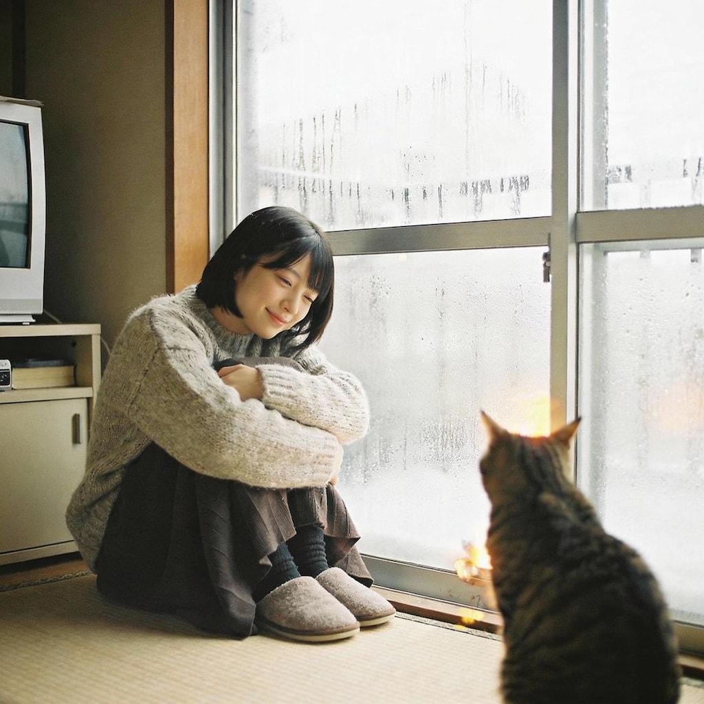 A Pensive Pause with Feline Company