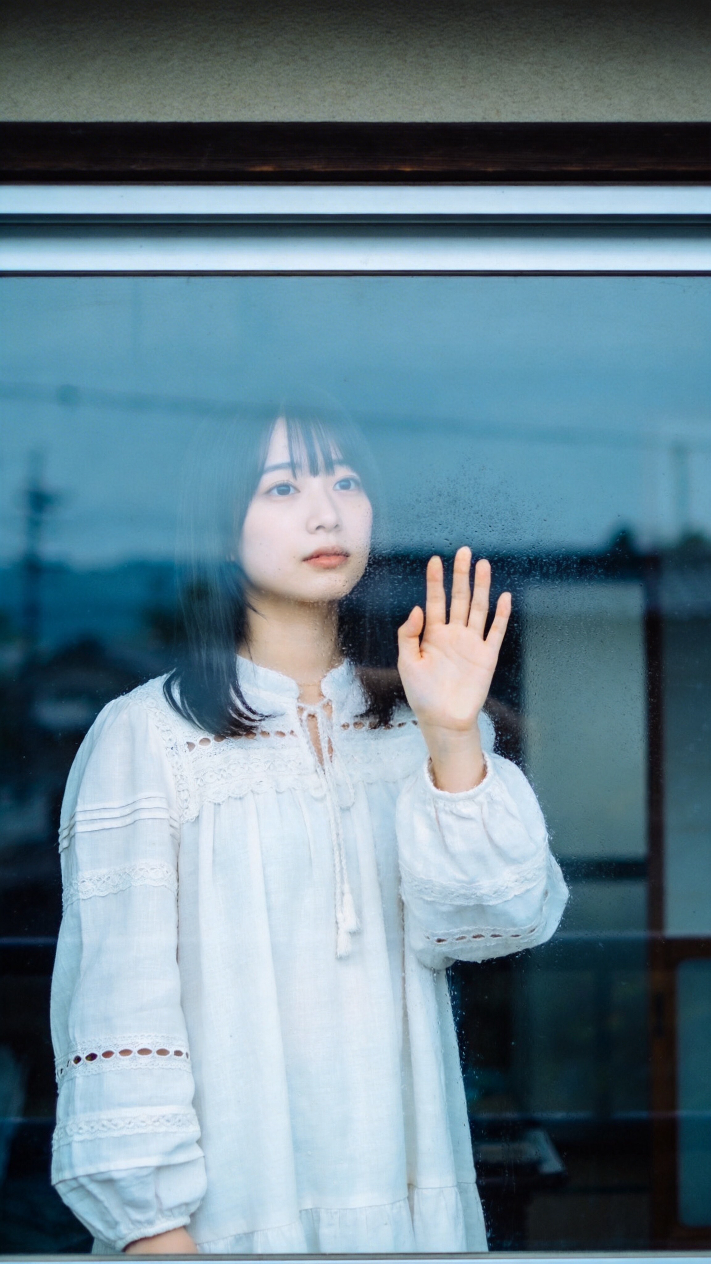 A Hand Against the Distance of Rain